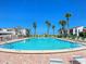 Enjoy the community pool with lounge chairs surrounded by lush tropical landscaping near the beach at 500 Park S Blvd # 33, Venice, FL 34285