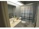 Well-lit bathroom includes a shower with a curtain, toilet, a sink with vanity, and a large mirror at 505 Duke Rd, Venice, FL 34293