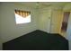 Simple bedroom with closet, carpeting, and window with decorative valance, offers practical living space at 505 Duke Rd, Venice, FL 34293