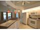 Functional kitchen with white appliances, ample cabinet space, and a breakfast bar overlooking the outdoor living area at 505 Duke Rd, Venice, FL 34293