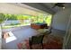 Enclosed patio features a relaxing hot tub, seating area, and view of the backyard at 505 Duke Rd, Venice, FL 34293