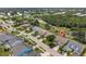 Aerial view of the home in a neighborhood with nearby ponds and lush greenery at 511 Wexford Dr, Venice, FL 34293