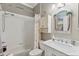 Charming bathroom with a shower-tub combo, marble countertops, and beach-themed decor at 511 Wexford Dr, Venice, FL 34293
