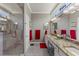 Modern bathroom featuring double sinks, a glass enclosed shower, and stylish granite countertops at 511 Wexford Dr, Venice, FL 34293