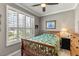 Relaxing bedroom featuring natural light, a ceiling fan, and shutters at 511 Wexford Dr, Venice, FL 34293