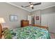 Bright bedroom featuring a large bed, natural light, and a ceiling fan at 511 Wexford Dr, Venice, FL 34293