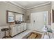 Inviting foyer with neutral paint, crown molding, tile flooring, and a decorative mirror at 511 Wexford Dr, Venice, FL 34293