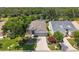 Beautiful front exterior of the home with a well-manicured lawn and mature trees at 511 Wexford Dr, Venice, FL 34293