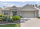 Charming single-story home featuring a well-maintained front yard and an attached two-car garage at 511 Wexford Dr, Venice, FL 34293