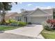 Front exterior of the house featuring a well-maintained lawn and an attached two-car garage at 511 Wexford Dr, Venice, FL 34293