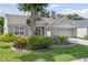 Charming front exterior with well-maintained landscaping and a two-car garage at 511 Wexford Dr, Venice, FL 34293