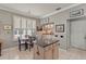 Cozy kitchen area with island, tile floors, and natural light from the window at 511 Wexford Dr, Venice, FL 34293