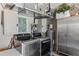 Well-organized laundry room with modern washer/dryer, storage cabinets, and a utility sink at 511 Wexford Dr, Venice, FL 34293