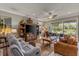 Comfortable living room featuring a large flat-screen television and access to the lanai with water view at 511 Wexford Dr, Venice, FL 34293
