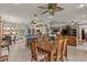 Open-concept living room with wood floors, ceiling fans, kitchen and dining area at 511 Wexford Dr, Venice, FL 34293
