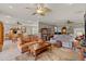 Open concept living area with wood-look flooring, neutral paint, and multiple seating areas at 511 Wexford Dr, Venice, FL 34293
