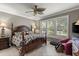 Comfortable main bedroom featuring a four-poster bed, ceiling fan, and peaceful decor at 511 Wexford Dr, Venice, FL 34293