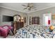 Spacious main bedroom featuring elegant furniture, a ceiling fan, and an organized walk-in closet at 511 Wexford Dr, Venice, FL 34293