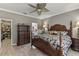 Comfortable main bedroom with ceiling fan, wooden furniture, and walk-in closet at 511 Wexford Dr, Venice, FL 34293