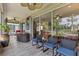 Covered patio features hot tub, seating and lake view at 511 Wexford Dr, Venice, FL 34293