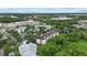 Overhead view of the condo surrounded by trees and greenery plus a pond nearby at 5134 Northridge Rd # 303, Sarasota, FL 34238