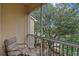 Relaxing screened balcony with a chair and table overlooking lush greenery at 5134 Northridge Rd # 303, Sarasota, FL 34238