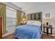 Cozy bedroom with a large window, designer headboard, and stylish accents at 5134 Northridge Rd # 303, Sarasota, FL 34238