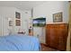 Well-lit bedroom with TV, dresser, and doorway leading to other rooms at 5134 Northridge Rd # 303, Sarasota, FL 34238