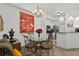 Elegant dining area with a glass table and a view of the kitchen at 5134 Northridge Rd # 303, Sarasota, FL 34238