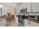 Bright kitchen with granite counters, stainless steel oven, and access to dining area at 5134 Northridge Rd # 303, Sarasota, FL 34238