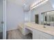 Well-lit bathroom featuring double vanity, large mirror, soaking tub, and modern finishes at 519 Catalina Isles Cir, Venice, FL 34292