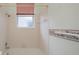 Bathroom features a tub with shower and a window at 519 Catalina Isles Cir, Venice, FL 34292