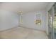 Bright bedroom with sliding doors to lanai, plush carpet, and a peaceful view at 519 Catalina Isles Cir, Venice, FL 34292