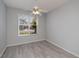 Bright bedroom with ceiling fan, luxury vinyl plank flooring, and a view of the outdoors at 519 Catalina Isles Cir, Venice, FL 34292