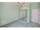 Bedroom features a large mirror closet door, green walls and trim at 519 Catalina Isles Cir, Venice, FL 34292