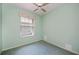Cozy bedroom features a ceiling fan and a large window at 519 Catalina Isles Cir, Venice, FL 34292