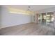 Spacious primary bedroom with neutral paint, wood flooring, and sliding doors to the lanai at 519 Catalina Isles Cir, Venice, FL 34292