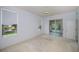 Bright bedroom with sliding glass doors to lanai, plush carpet, and a tranquil view at 519 Catalina Isles Cir, Venice, FL 34292