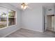 Well-lit bedroom with ceiling fan, large window with blinds, and luxury vinyl plank flooring at 519 Catalina Isles Cir, Venice, FL 34292