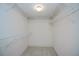 Walk-in closet with built-in white wire shelving for maximum storage and organization at 519 Catalina Isles Cir, Venice, FL 34292