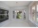 Charming dining area with large windows showcasing outdoor views and a stylish chandelier at 519 Catalina Isles Cir, Venice, FL 34292