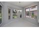 Dining area with large windows offering serene backyard views and a stylish chandelier at 519 Catalina Isles Cir, Venice, FL 34292