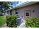 Home exterior featuring mature landscaping, a side door entrance, and an efficient air conditioning unit at 519 Catalina Isles Cir, Venice, FL 34292