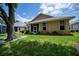 Rear view of home with mature landscaping, and screened porch at 519 Catalina Isles Cir, Venice, FL 34292
