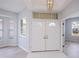 Elegant foyer featuring high ceilings, a modern light fixture, and double entry doors at 519 Catalina Isles Cir, Venice, FL 34292