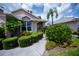 This home includes pruned hedges, flowering bushes, and well-maintained walkways at 519 Catalina Isles Cir, Venice, FL 34292