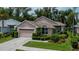 Charming single-story home boasts lush landscaping, a two-car garage, and a neatly maintained front yard at 519 Catalina Isles Cir, Venice, FL 34292
