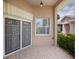 Covered front porch featuring patterned tile flooring, security doors, and an overhead light fixture at 519 Catalina Isles Cir, Venice, FL 34292