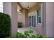 Covered front porch with tiled flooring, decorative security doors, and a view of lush greenery at 519 Catalina Isles Cir, Venice, FL 34292