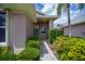 Inviting front porch with tiled flooring, decorative security doors, and manicured landscaping at 519 Catalina Isles Cir, Venice, FL 34292